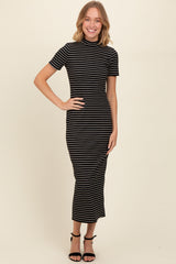 woman wearing a black and white striped midi dress with a high neckline and short sleeves