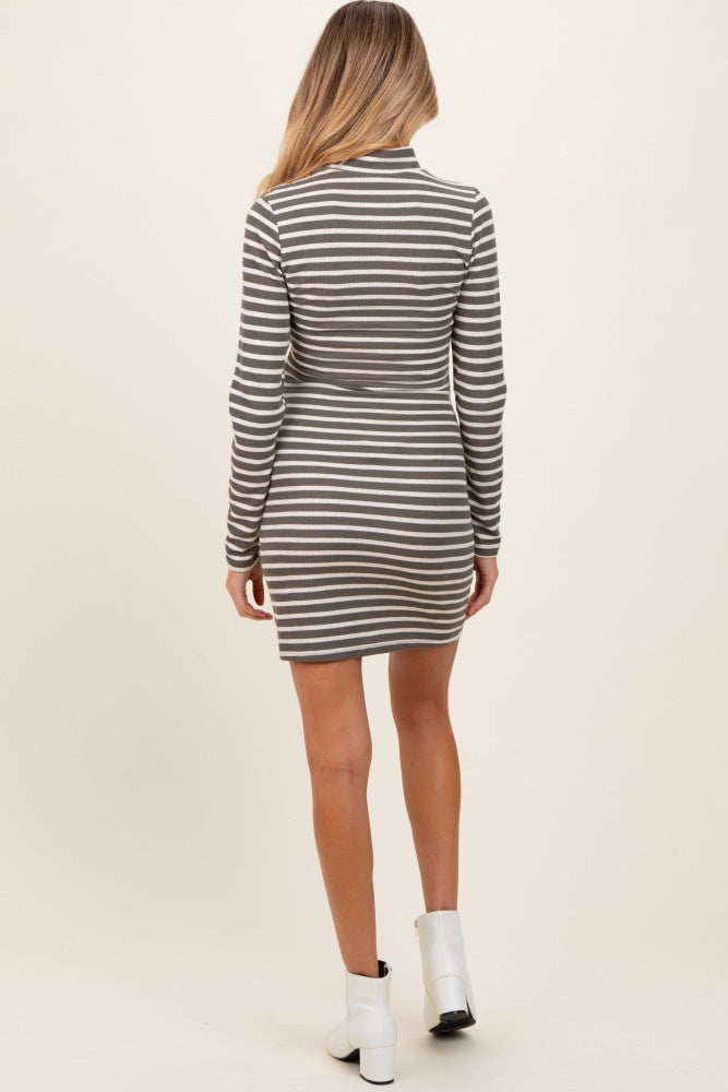 woman wearing a grey and white striped long sleeve maternity dress, seen from the back
