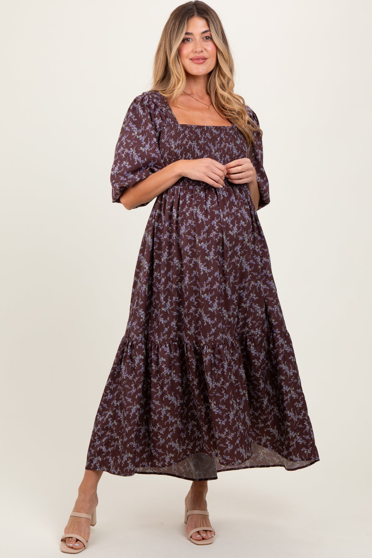 woman wearing a purple floral maternity maxi dress with square neckline and short puff sleeves