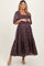 woman wearing a purple floral maternity maxi dress with square neckline and short puff sleeves