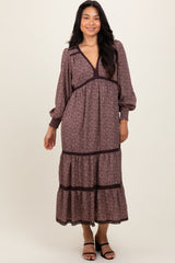 woman wearing a floral long sleeve maxi dress with a deep v-neck and tiered skirt