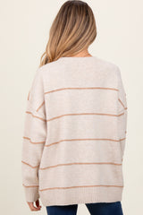 woman wearing a beige maternity sweater with light brown stripes, shown from the back