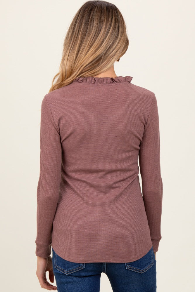 woman wearing a mauve long sleeve maternity top with ruffle detail at the neckline, viewed from the back