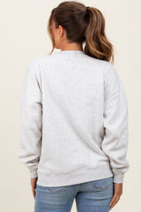 woman wearing a light gray maternity sweatshirt with a relaxed fit and long sleeves, view from the back