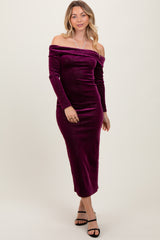 woman wearing a off-the-shoulder purple velvet midi dress with long sleeves and a fitted silhouette