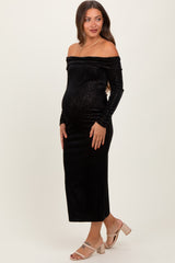 woman wearing a black off-shoulder maternity dress with long sleeves and a baby bump visible
