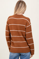 woman wearing a brown striped sweater with a relaxed fit and ribbed hem, view from the back