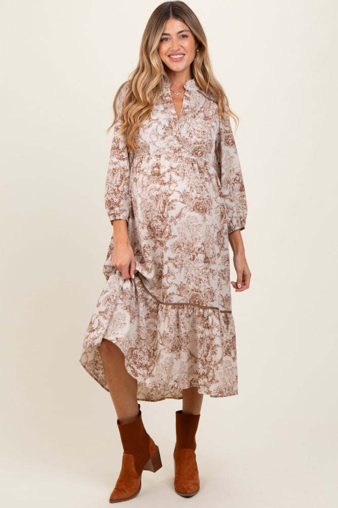woman wearing a floral patterned maternity dress with a high-low hem and 3/4 sleeves, showing her baby bump