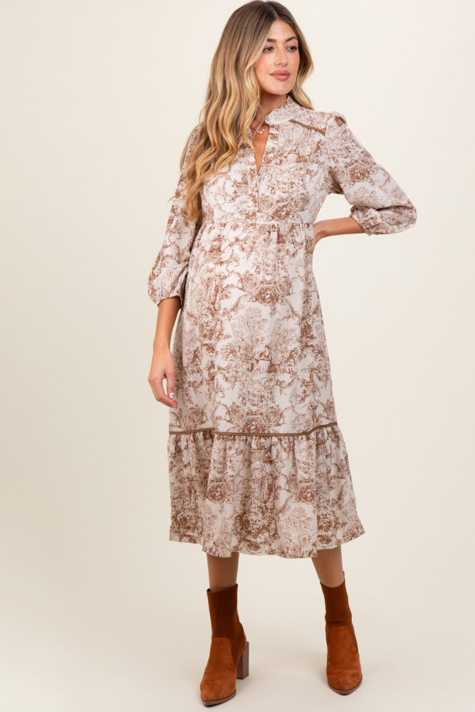 woman wearing a floral print maternity dress with a tiered hem and long sleeves, showing her baby bump