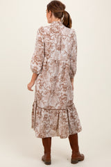 woman wearing a long floral print dress with three-quarter sleeves and a ruffled hem, seen from the back