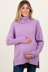 woman wearing a lavender turtleneck maternity sweater and cradling her baby bump