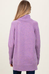 woman wearing a lavender maternity sweater with a turtleneck and ribbed cuffs, shown from the back