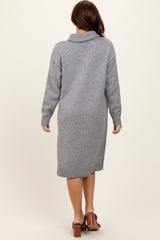 woman wearing a gray knit sweater dress with a high collar and long sleeves, viewed from the back