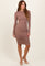 woman wearing a brown long sleeve fitted dress with ruched details and high neckline