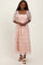 woman wearing a pink floral lace maxi dress with puff sleeves and a square neckline