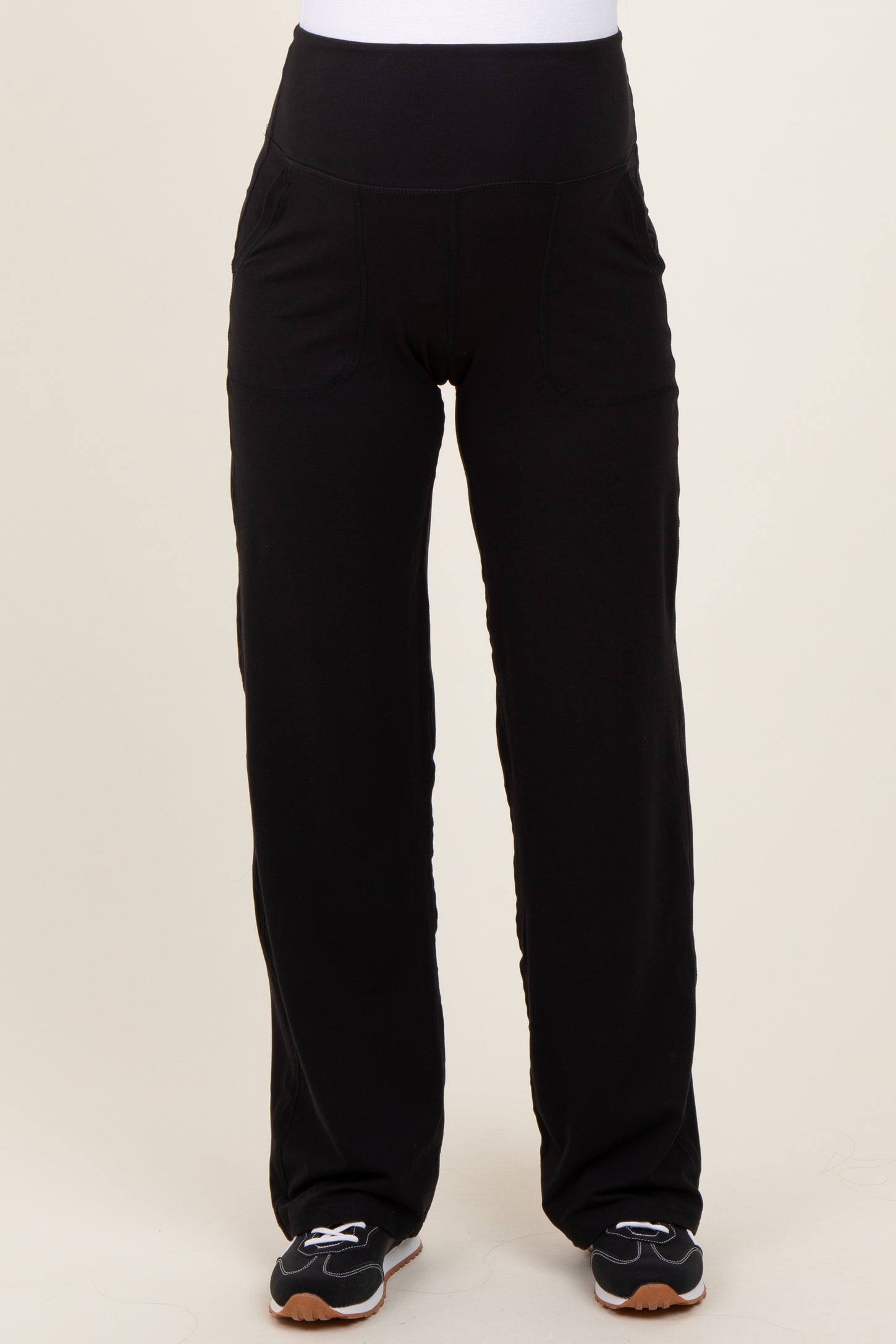 woman wearing black maternity pants with a supportive waistband and pockets