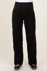 woman wearing black maternity pants with a supportive waistband and pockets
