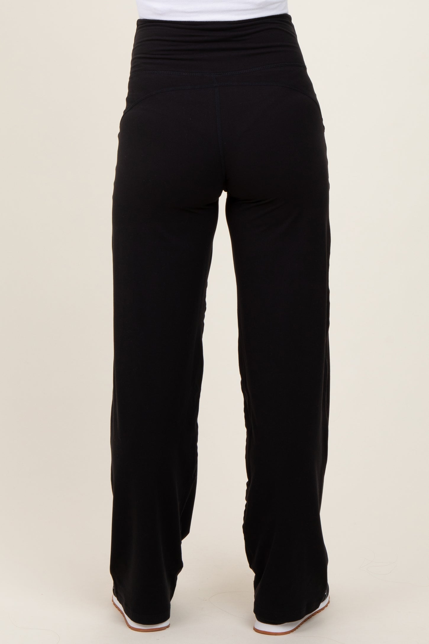 woman wearing black maternity wide-leg pants, view from the back