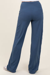 woman wearing slate blue wide-leg pants with a high waistband and pockets, viewed from the back