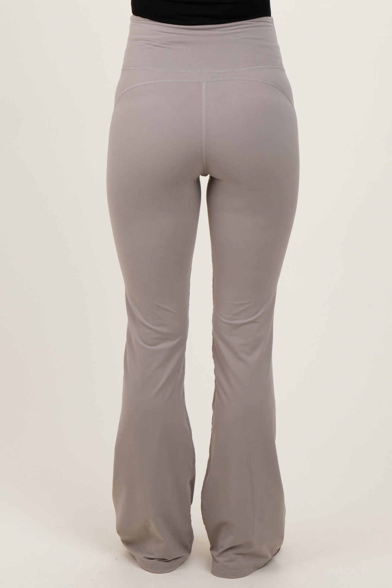 maternity wear light gray flared yoga pants with a high waistband, shown from the back