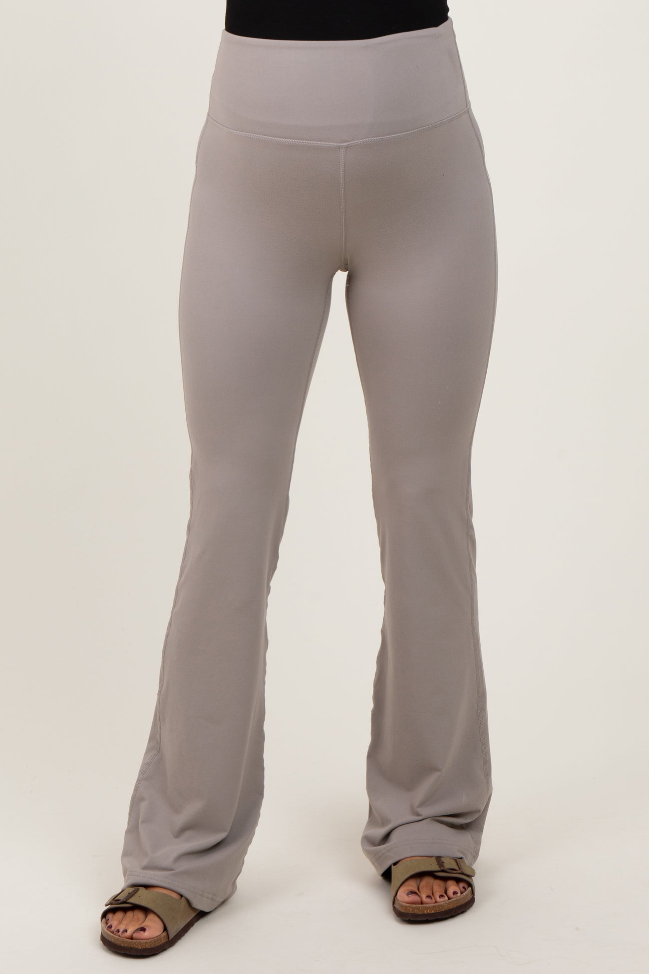 woman wearing light gray maternity flare leggings with a wide waistband