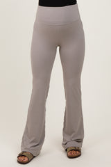 woman wearing light gray maternity flare leggings with a wide waistband