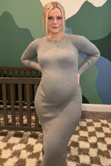 woman wearing a grey ribbed maternity dress and showing her baby bump