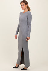 woman wearing a grey ribbed long sleeve maxi dress with a side slit and black heels