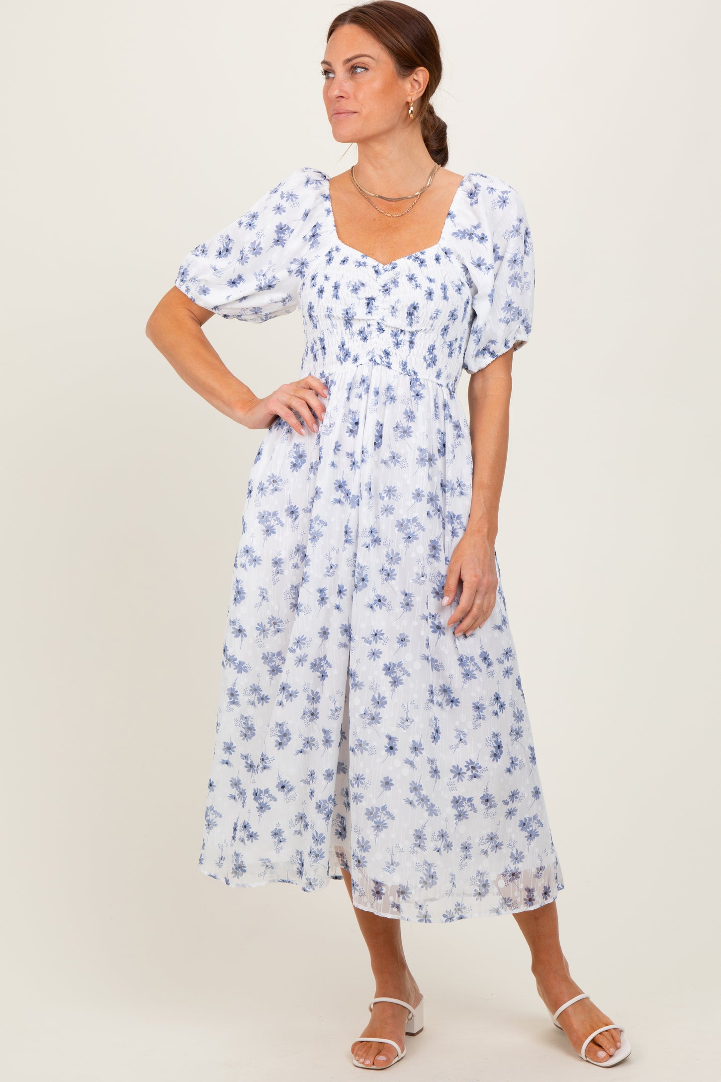 woman wearing a white floral midi dress with puff sleeves and square neckline