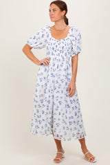 woman wearing a white floral midi dress with puff sleeves and square neckline
