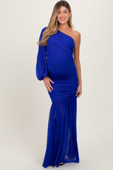 woman wearing a royal blue one-shoulder maternity gown with ruched detailing and a flowing skirt, highlighting her baby bump