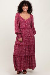 woman wearing a red floral tiered maxi dress with long sleeves and a scooped neckline
