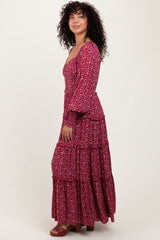 woman wearing a red floral maxi dress with tiered ruffles and long sleeves