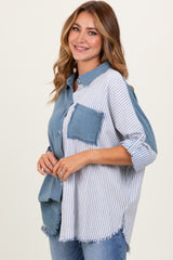 woman wearing a blue and white striped button-up shirt with a distressed pocket and sleeves rolled up