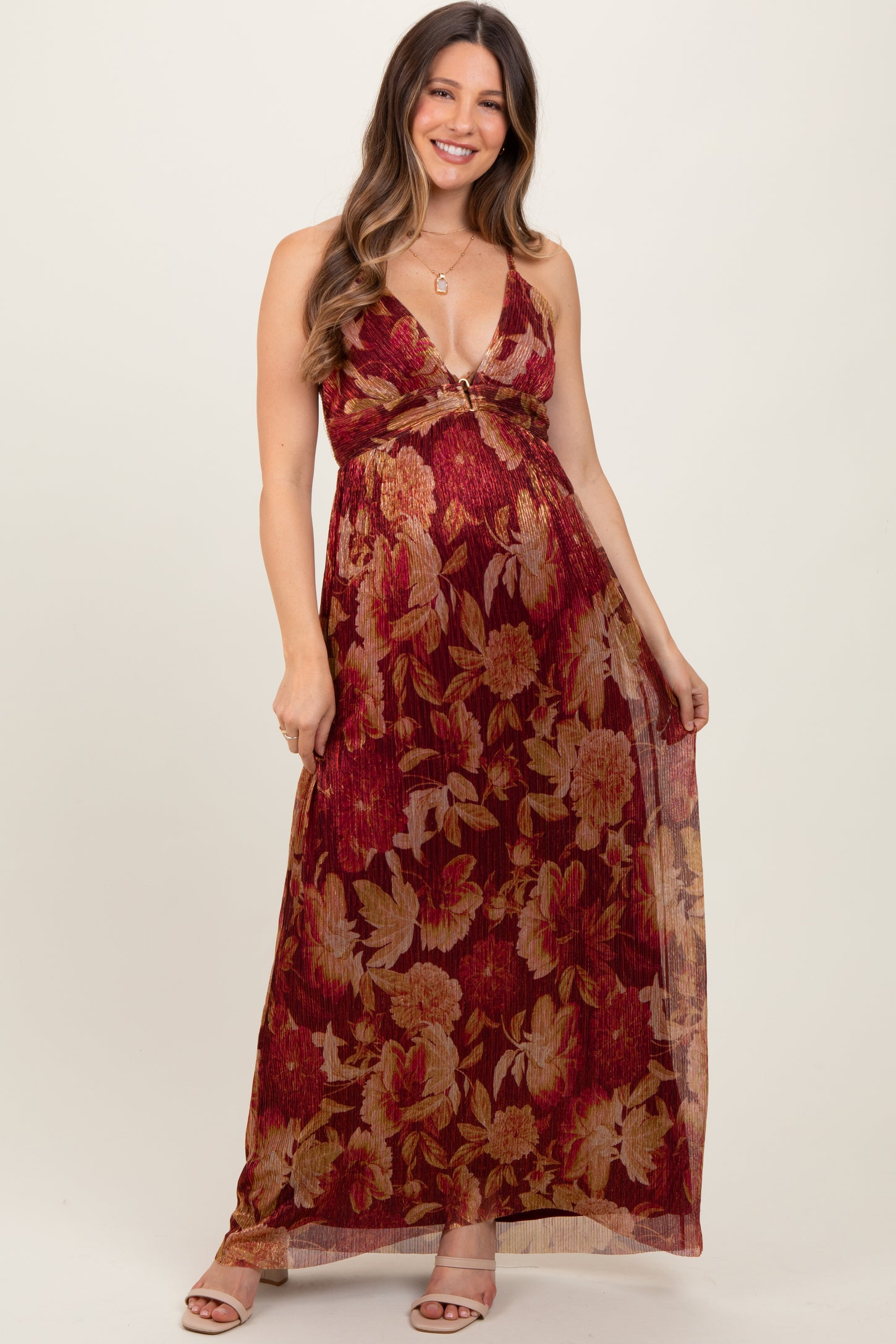 woman wearing a burgundy floral maternity maxi dress with a deep v-neck and empire waist, showcasing her baby bump