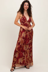 woman wearing a red floral maxi dress with spaghetti straps and a deep v-neckline