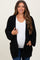 woman wearing a black chunky knit maternity cardigan over a white top and showing her baby bump
