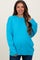 woman wearing a bright blue oversized maternity sweater with ribbed hem and cuffs
