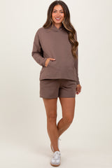 woman wearing a brown maternity hoodie with a front pocket and matching shorts