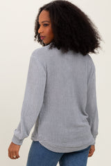 woman wearing a gray long sleeve textured knit top with a relaxed fit and casual style