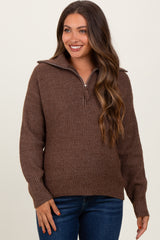 woman wearing a brown textured maternity sweater with a half-zip and relaxed fit, smiling at the camera