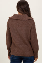 woman wearing a brown oversized maternity sweater with a cozy collar, viewed from the back