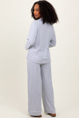 woman wearing a gray long sleeve top and matching wide-leg pants, viewed from the back
