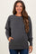 woman wearing a dark gray maternity sweatshirt with side pockets and raglan sleeves, showing a baby bump