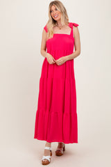 woman wearing a hot pink tiered maxi dress with tie straps and a relaxed fit