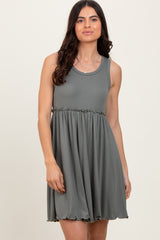 woman wearing a fitted olive green tank dress with a flared skirt and ribbed texture