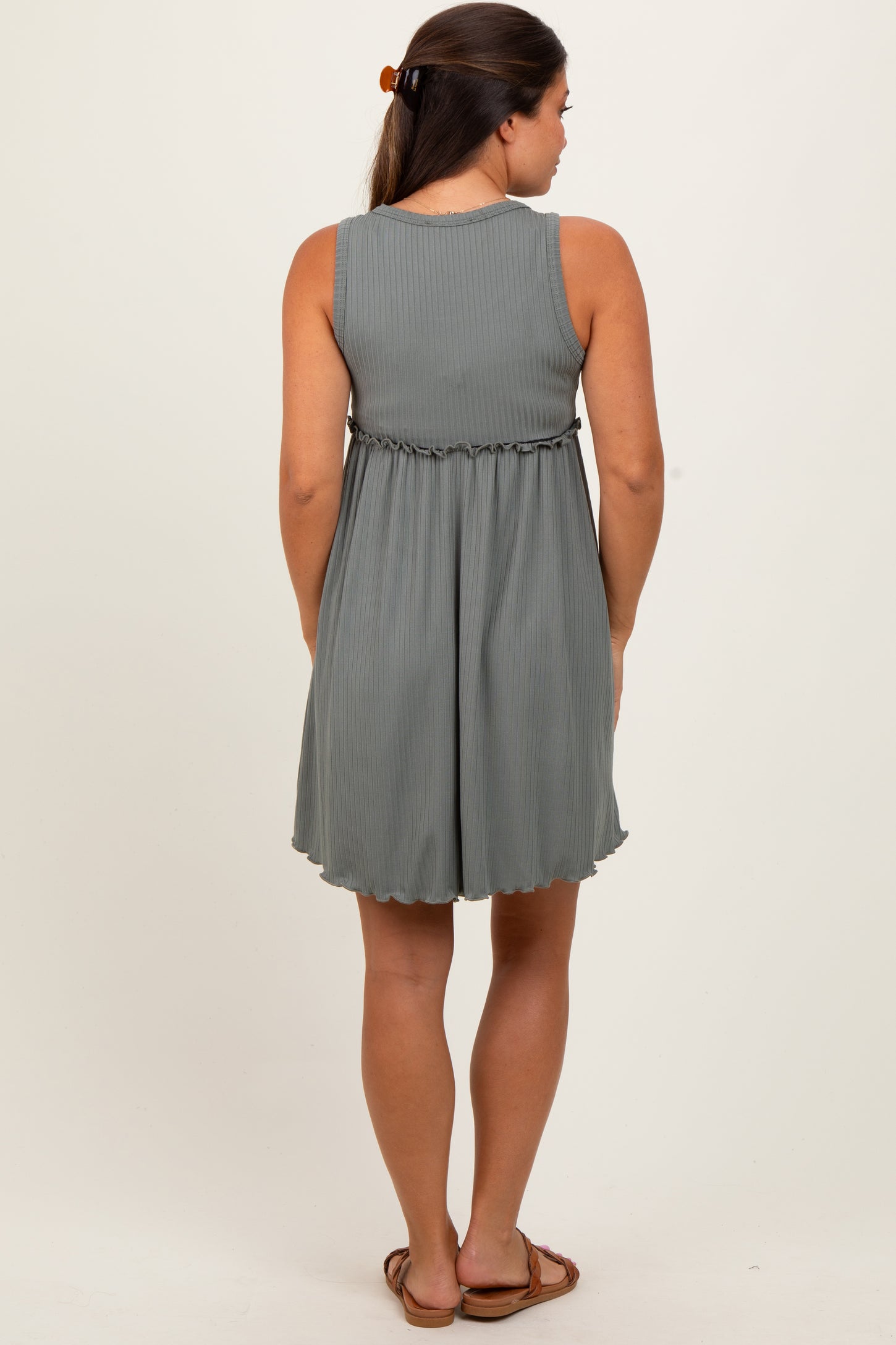 woman wearing a grey ribbed maternity dress with a gathered waist and a flared skirt, seen from the back