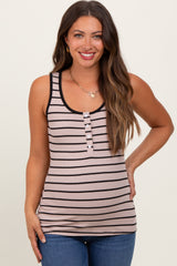 woman wearing a striped maternity tank top with buttons and holding her baby bump