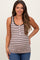 woman wearing a striped maternity tank top with buttons and holding her baby bump