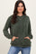 woman wearing a green striped long sleeve hoodie with a front pocket and drawstring, styled with blue jeans
